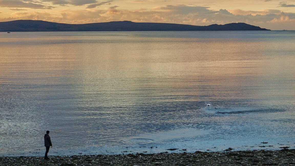Skimming stone at sunset on Ardmair Beach, Scotland